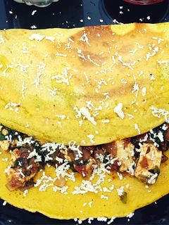 A picture of Besan chilla with palak paneer stuffing.