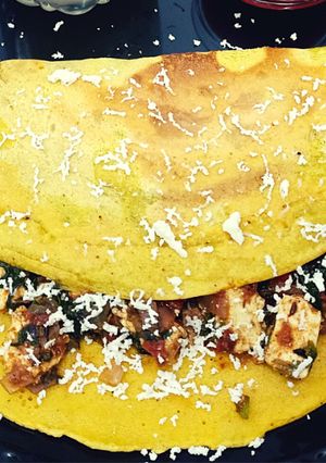 A picture of Besan chilla with palak paneer stuffing.