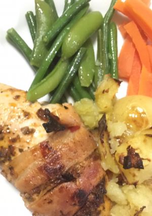 A picture of Baked Chicken with pesto and bacon.