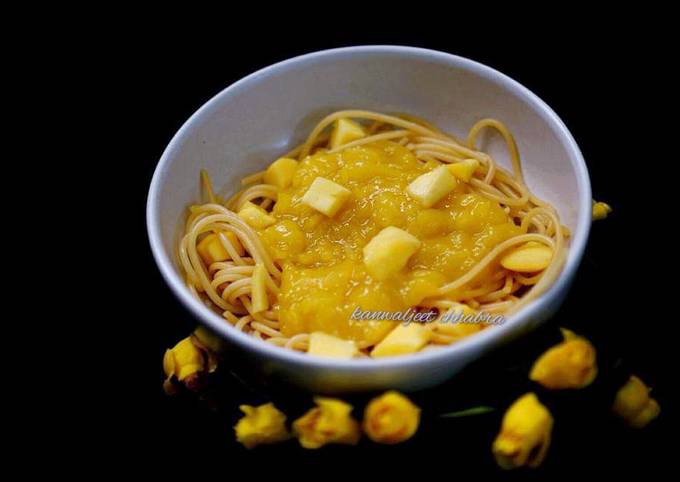 Spaghetti in mango sauce topped with mango cubes