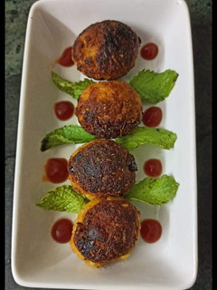A picture of Leftover rice ka makeover....Rice corn vada in appam pan.
