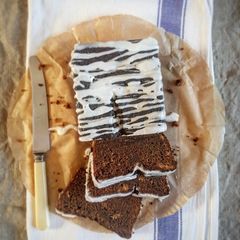 A picture of Sticky Ginger Loaf Cake with Lemon Icing.
