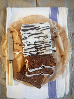 A picture of Sticky Ginger Loaf Cake with Lemon Icing.