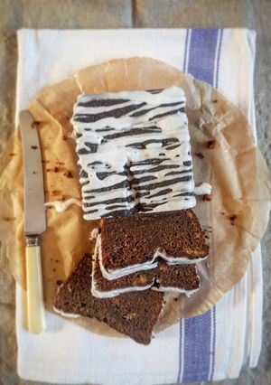 A picture of Sticky Ginger Loaf Cake with Lemon Icing.
