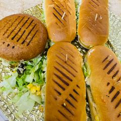 A picture of Saucy veggies & corn burgers 🍔.