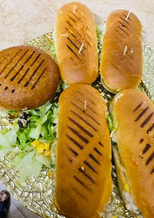 A picture of Saucy veggies & corn burgers 🍔.