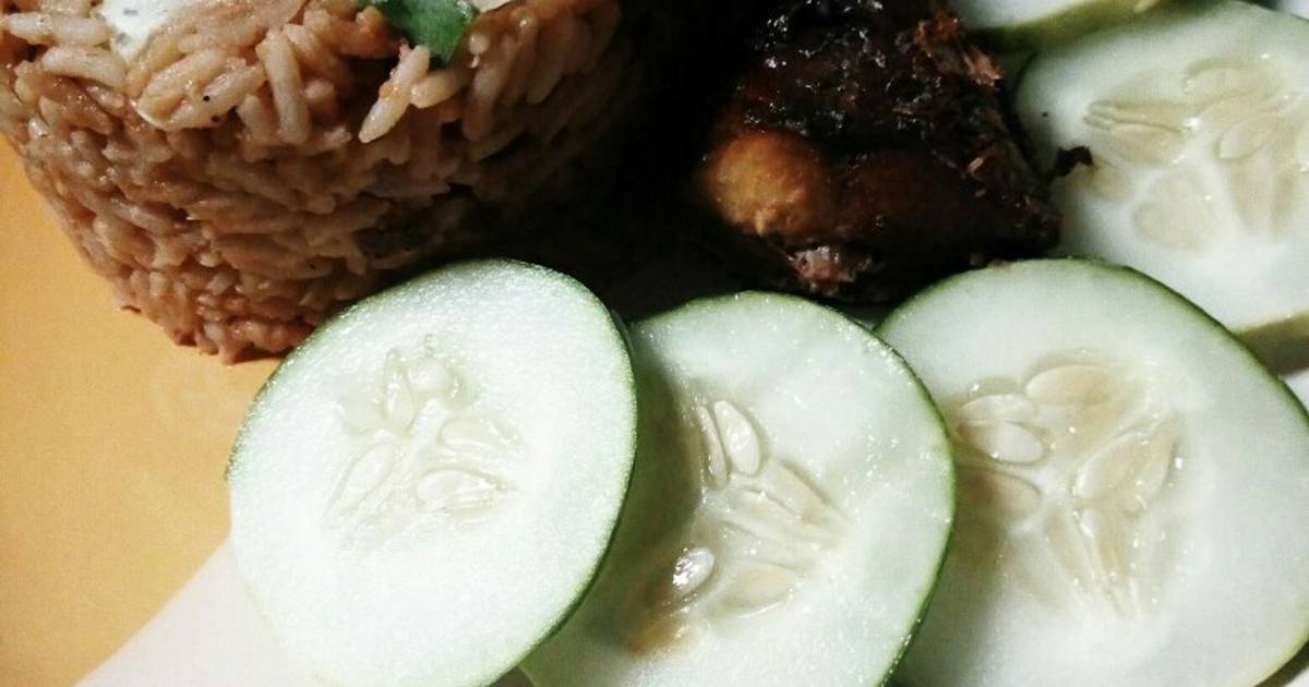 Turmeric jollof rice with cucumber and fried fish Recipe by Annie Pius