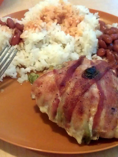 A picture of stuffed chicken wrapped in bacon.
