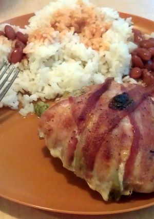 A picture of stuffed chicken wrapped in bacon.