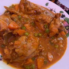 A picture of Chicken stew with peas.