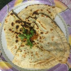 A picture of Cheese paratha with lots of spinach.