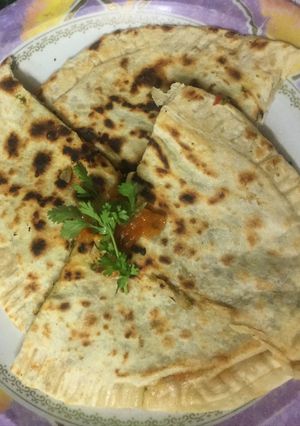 A picture of Cheese paratha with lots of spinach.