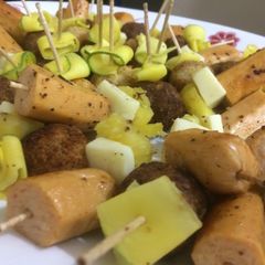 A picture of Sausage with Cheese and Pineapple Sticks.