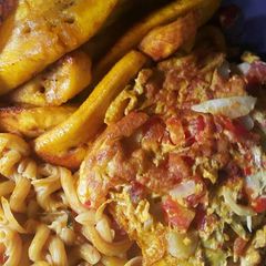 A picture of Macroni with fried plantain and fried egg.