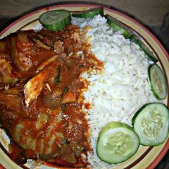 A picture of White Rice with catfish pepper soup and cucumber.