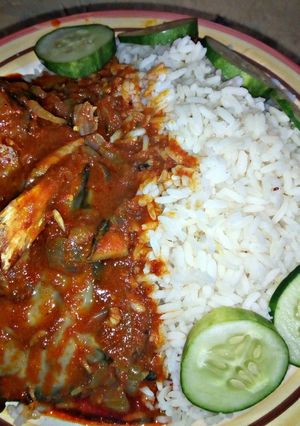 A picture of White Rice with catfish pepper soup and cucumber.