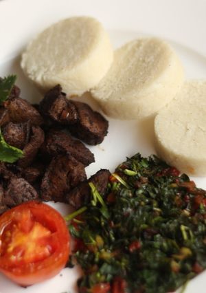 A picture of Ugali maini(beef liver with ugali and sauted spinach.