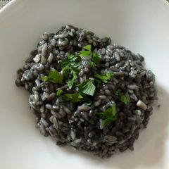 A picture of Risotto Nero di seppia squid ink risotto.