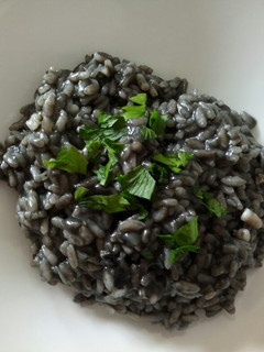 A picture of Risotto Nero di seppia squid ink risotto.