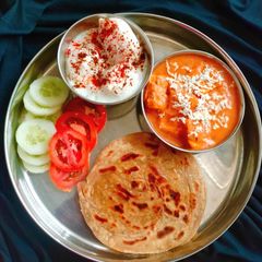 A picture of PUNJABI THALI (Shahi paneer,laccha paratha with Dahi Bhalla).