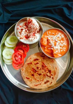 A picture of PUNJABI THALI (Shahi paneer,laccha paratha with Dahi Bhalla).