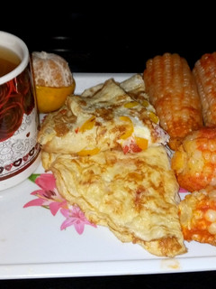 A picture of Boiled maize in tomatoes.