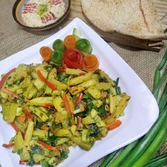 A picture of Stir fried zucchini with baba ganouj salad spread.