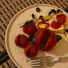 A picture of Feta, rosemary, tomatoes.