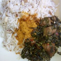 A picture of Rice and beans with vegetable souse.
