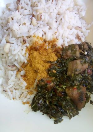 A picture of Rice and beans with vegetable souse.