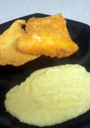 A picture of Fried Swai & Cheddar cheese grits.