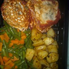 A picture of Breakfast idea- Fried Egg in Roasted tomato ring, veggies, stir fried potatoes.