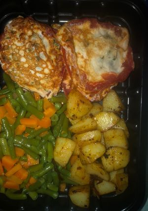 A picture of Breakfast idea- Fried Egg in Roasted tomato ring, veggies, stir fried potatoes.