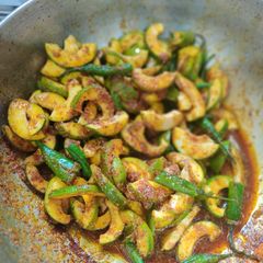 A picture of Kacha aam and green chilli instant achaar in making.