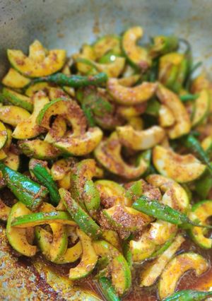 A picture of Kacha aam and green chilli instant achaar in making.