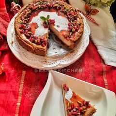 A picture of Cheese Cake with Pomegranate compote.