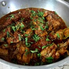 A picture of Dhaba style chicken karahi and homemade roti.