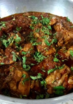 A picture of Dhaba style chicken karahi and homemade roti.