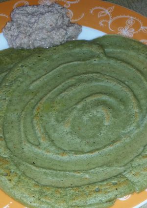 A picture of Pesarattu (green gram dosa) with onion chutney.
