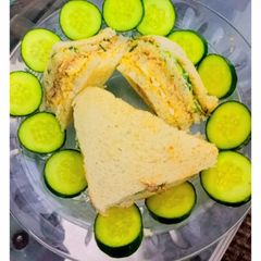 A picture of 3 layered ~chicken tikka club sandwich.