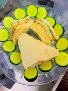 A picture of 3 layered ~chicken tikka club sandwich.