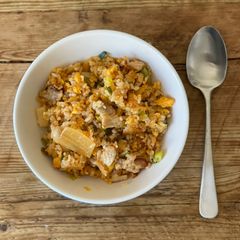 A picture of Fried rice with Korean Kimchi and pork belly.