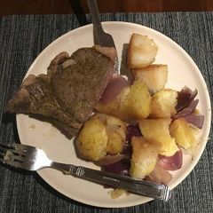 A picture of Baked onion potato and beef chunk.