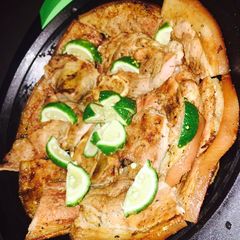 A picture of Grilled pork on charcoal.