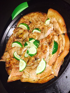 A picture of Grilled pork on charcoal.