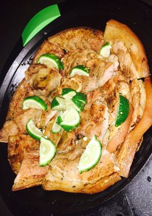 A picture of Grilled pork on charcoal.