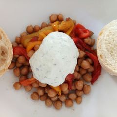 A picture of Grilled peppers and roasted chickpeas with tzatziki sauce.