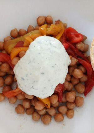 A picture of Grilled peppers and roasted chickpeas with tzatziki sauce.