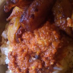 A picture of White rice, stew and fried plaintain.