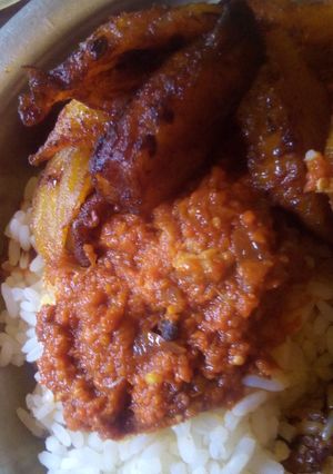 A picture of White rice, stew and fried plaintain.